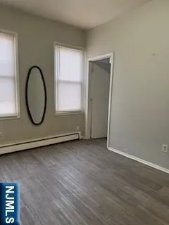 a view of a room with wooden floor and a window