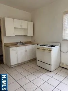 a utility room with sink dryer and washer