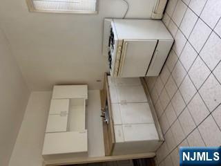 1131 Main Street Paterson, NJ 07503 - Photo 4 of 10 a utility room with sink dryer and washer