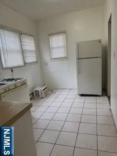 a kitchen with a stove a refrigerator and a sink