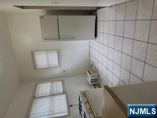 1131 Main Street Paterson, NJ 07503 - Photo 5 of 10 a kitchen with a stove a refrigerator and a sink