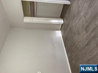 1131 Main Street Paterson, NJ 07503 - Photo 8 of 10 a view of an empty room with wooden floor and closet