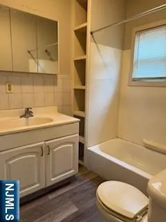 a bathroom with a sink a toilet and bathtub