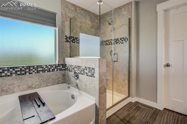 2085 Reed Grass Way Colorado Springs, CO 80915 - Photo 22 of 25 New glass shower surround. Soaking garden tub for those long days.