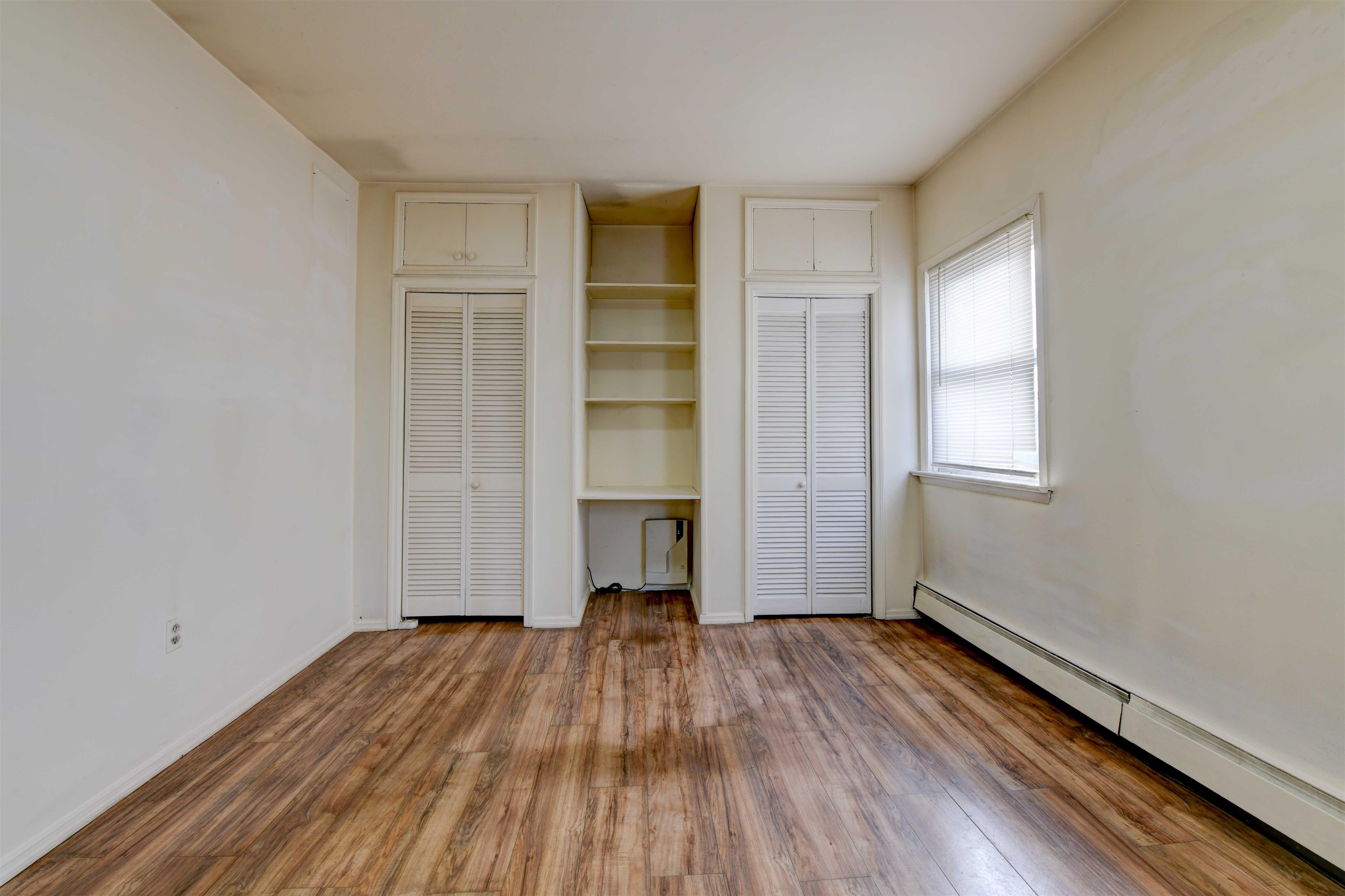 625 Harrison Avenue, Unit 2 Harrison, NJ 07029 - Photo 14 of 25 an empty room with wooden floor closet and windows
