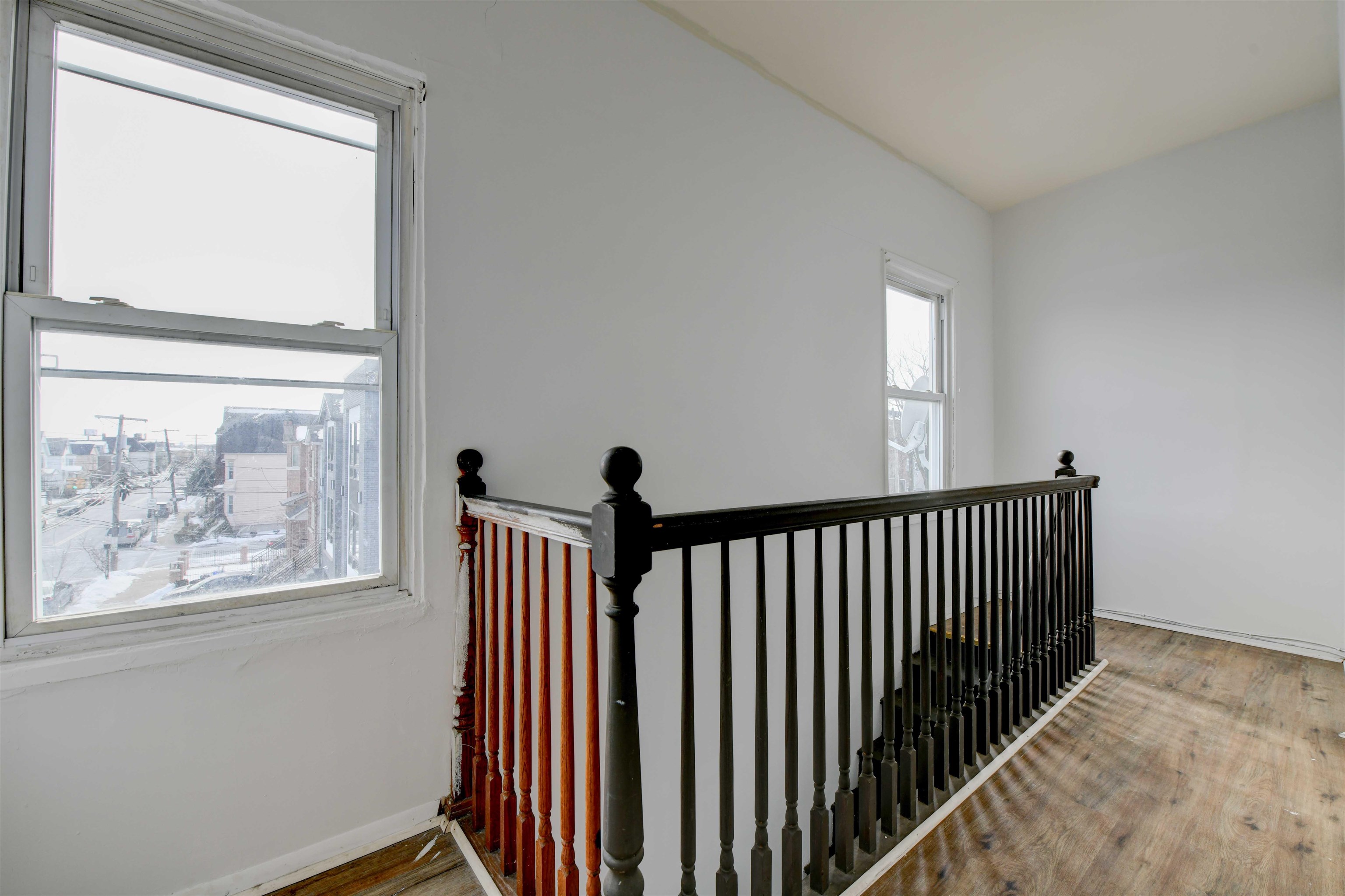 625 Harrison Avenue, Unit 2 Harrison, NJ 07029 - Photo 21 of 25 a view of a hallway with wooden floor and a window