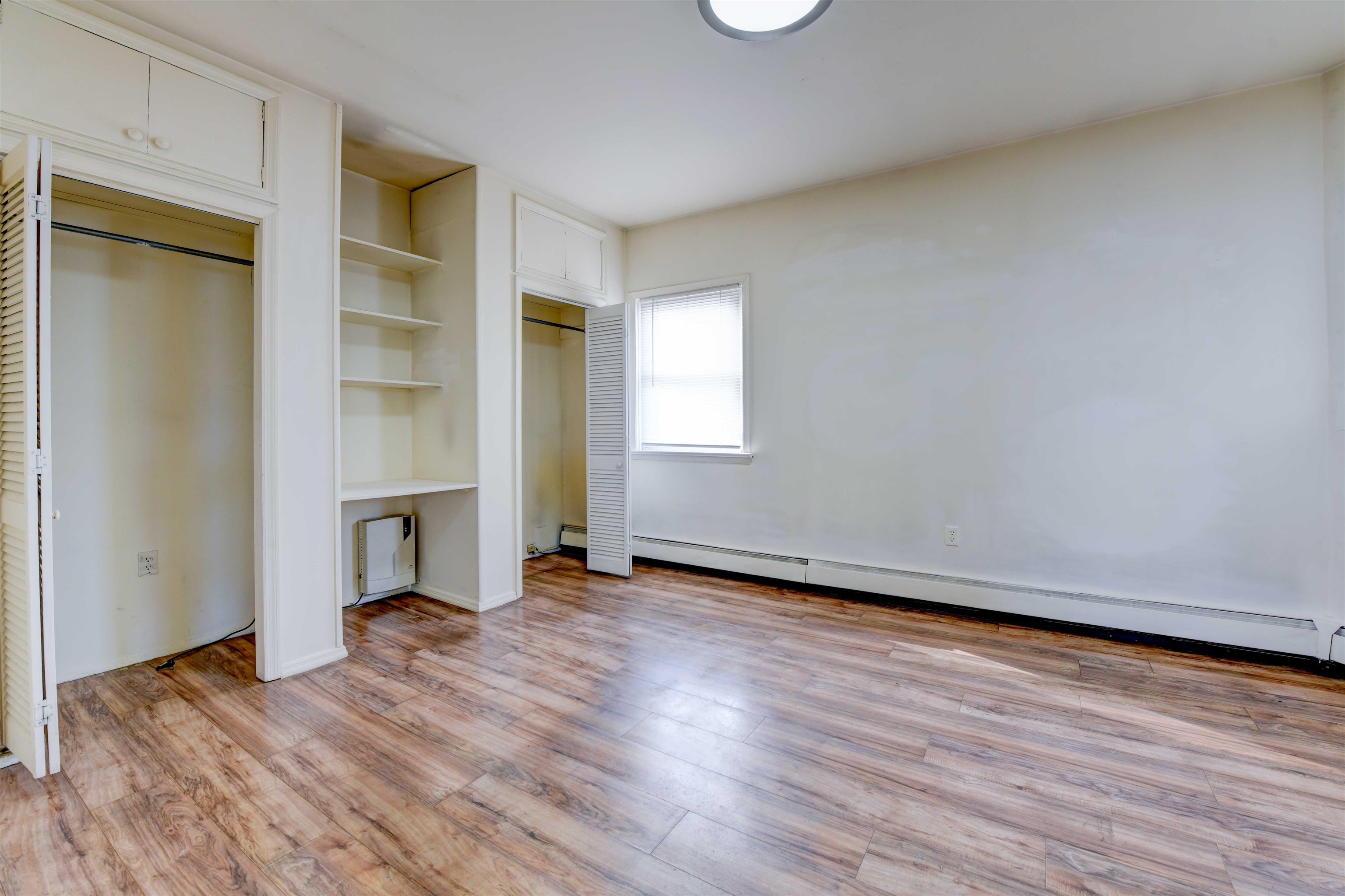 625 Harrison Avenue, Unit 2 Harrison, NJ 07029 - Photo 24 of 25 an empty room with wooden floor fireplace and windows
