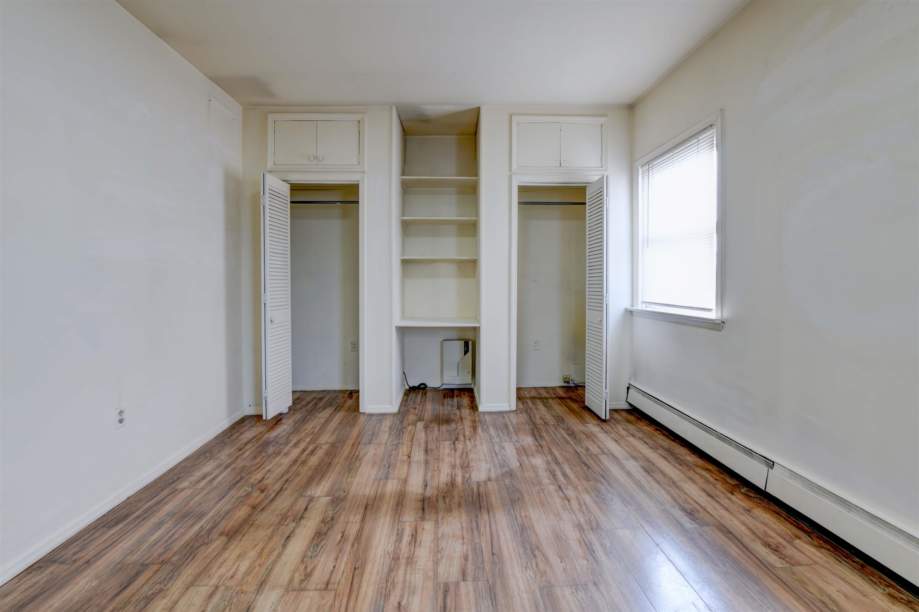 625 Harrison Avenue, Unit 2 Harrison, NJ 07029 - Photo 25 of 25 an empty room with wooden floor closet and windows
