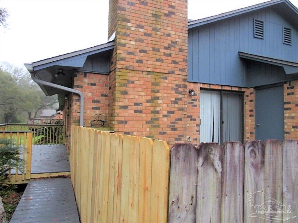 3322 Pine Forest Road Cantonment, FL 32533 - Photo 2 of 9 a front view of a house with wooden fence