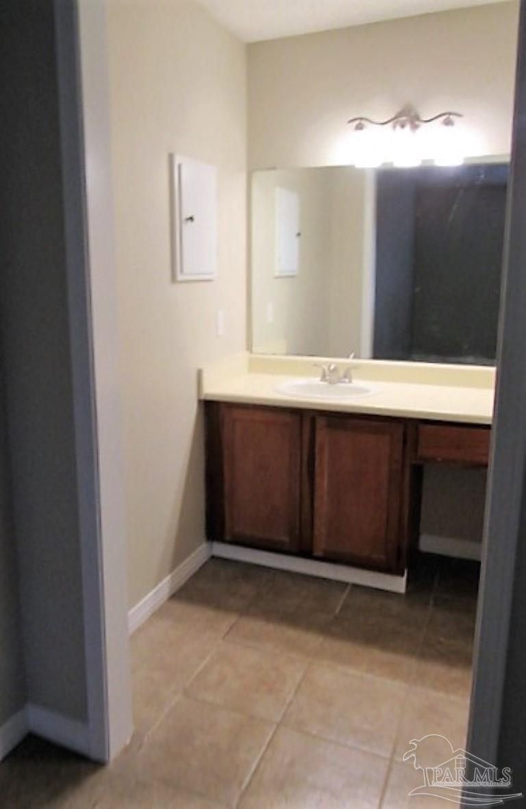 3322 Pine Forest Road Cantonment, FL 32533 - Photo 7 of 9 a bathroom with a sink and mirror