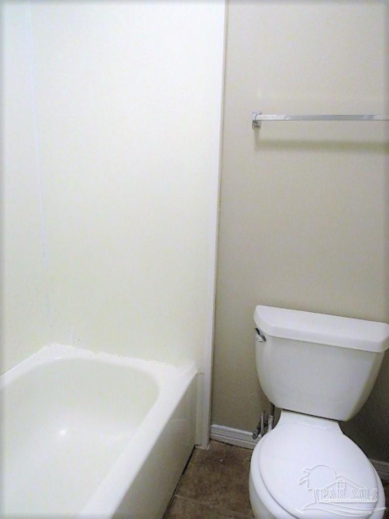 3322 Pine Forest Road Cantonment, FL 32533 - Photo 8 of 9 a white toilet sitting next to a bath tub