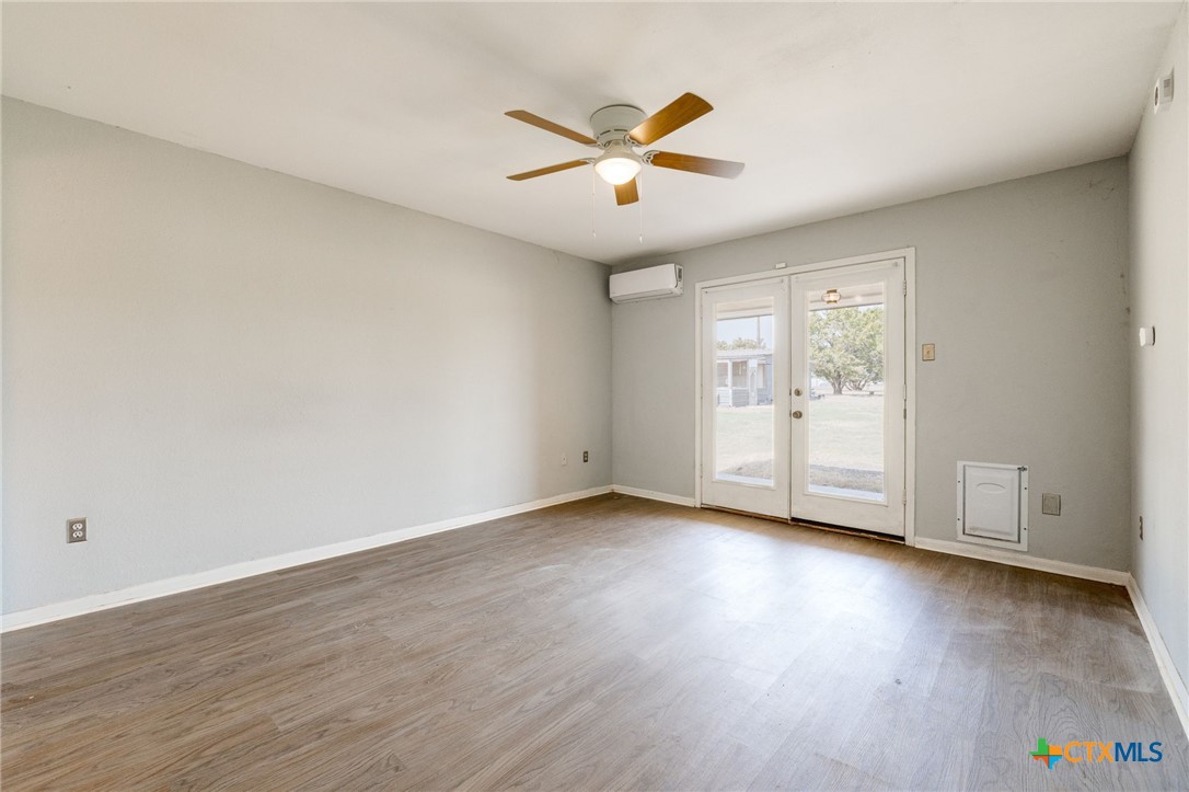 554 County Road 4707 Kempner, TX 76539 - Photo 12 of 33 a view of an empty room with wooden floor and a window