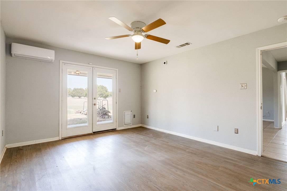 554 County Road 4707 Kempner, TX 76539 - Photo 13 of 33 an empty room with wooden floor and windows
