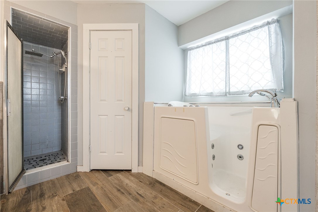 554 County Road 4707 Kempner, TX 76539 - Photo 16 of 33 a view of a kitchen with white cabinets and wooden floor