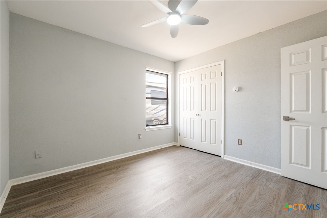 554 County Road 4707 Kempner, TX 76539 - Photo 21 of 33 an empty room with wooden floor and windows