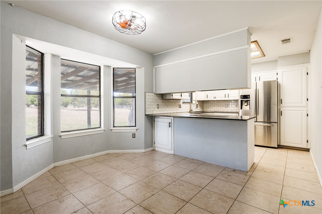 554 County Road 4707 Kempner, TX 76539 - Photo 8 of 33 a kitchen with stainless steel appliances granite countertop a refrigerator and a sink