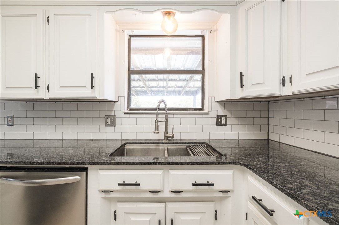 554 County Road 4707 Kempner, TX 76539 - Photo 10 of 33 a kitchen with granite countertop a sink window and cabinets