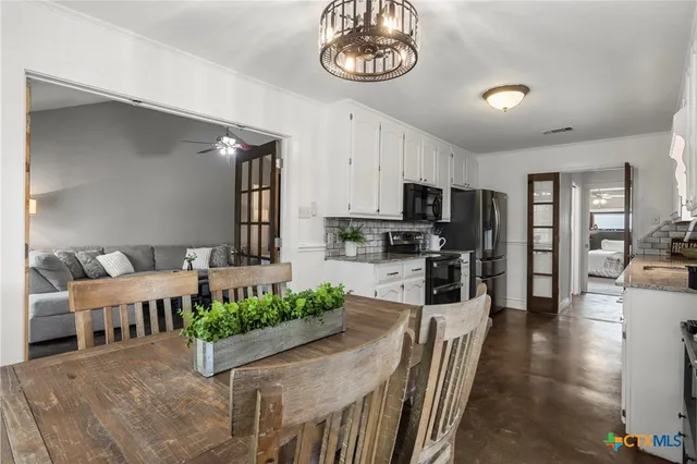 a large kitchen with a table and chairs