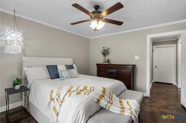 a bedroom with a bed and a ceiling fan