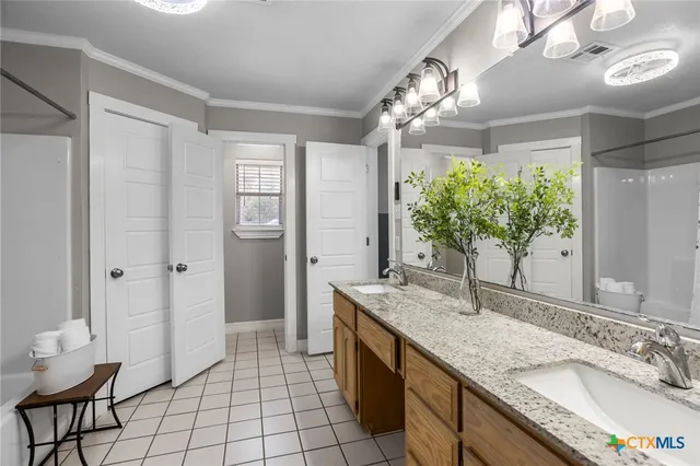 a spacious bathroom with a granite countertop sink a mirror and a shower