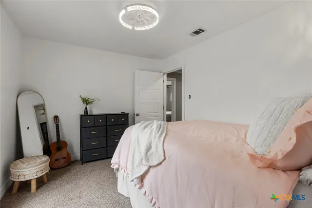 a bedroom with a bed and a mirror