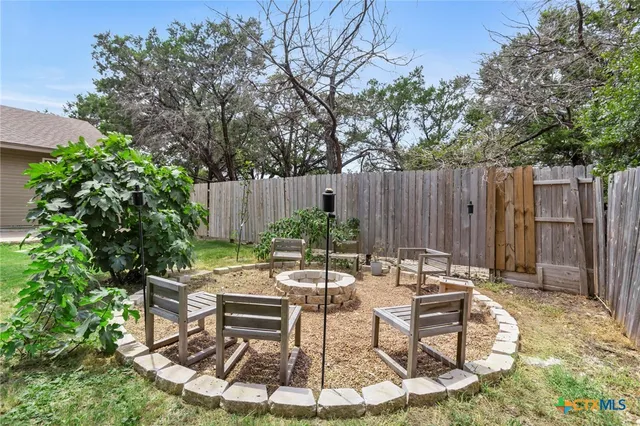 a view of a chairs and table in backyard