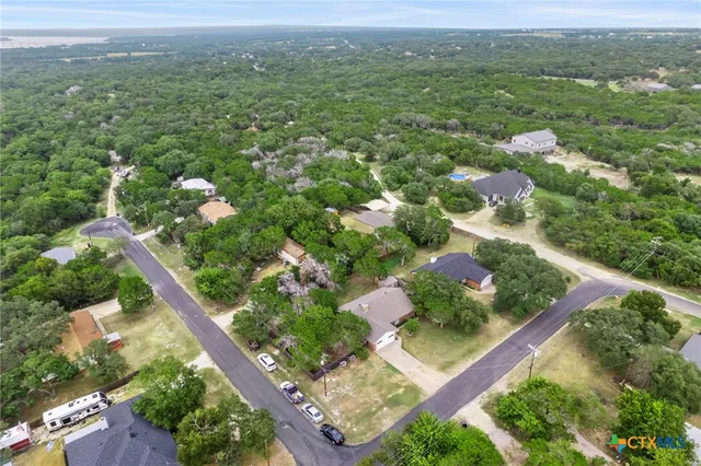 an aerial view of a house with a yard