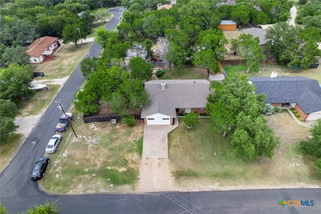 an aerial view of a house with a yard
