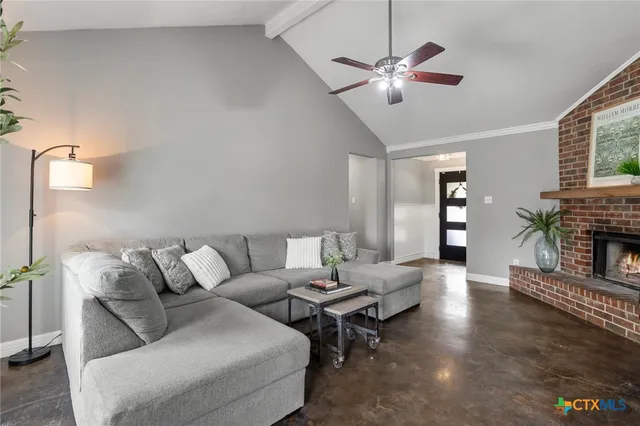 a living room with furniture and a fireplace