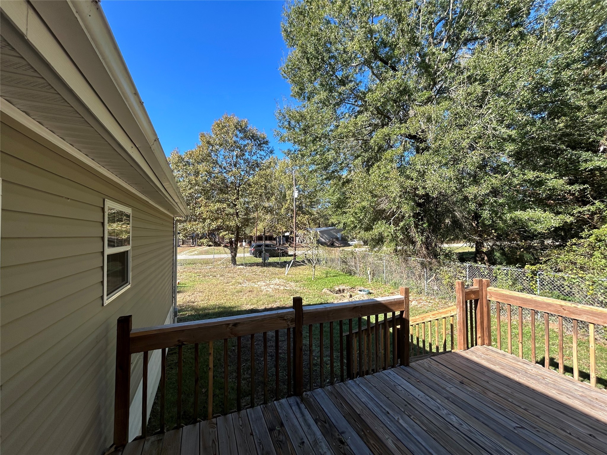 239 St Lucia Lane Point Blank, TX 77364 - Photo 2 of 6 a view of a wooden deck and a yard