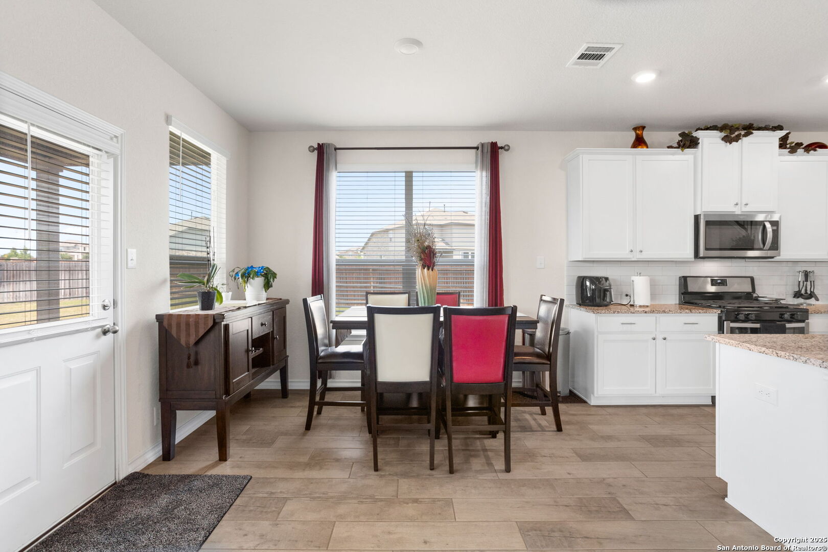 104 Mossy Bank Cibolo, TX 78108 - Photo 12 of 30 a dining room with furniture a window and a kitchen view