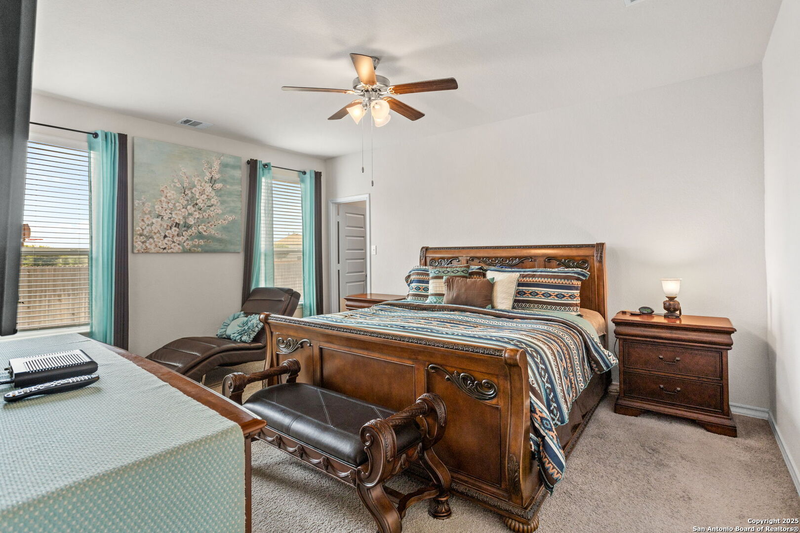 104 Mossy Bank Cibolo, TX 78108 - Photo 5 of 30 a bedroom with a bed and a chandelier