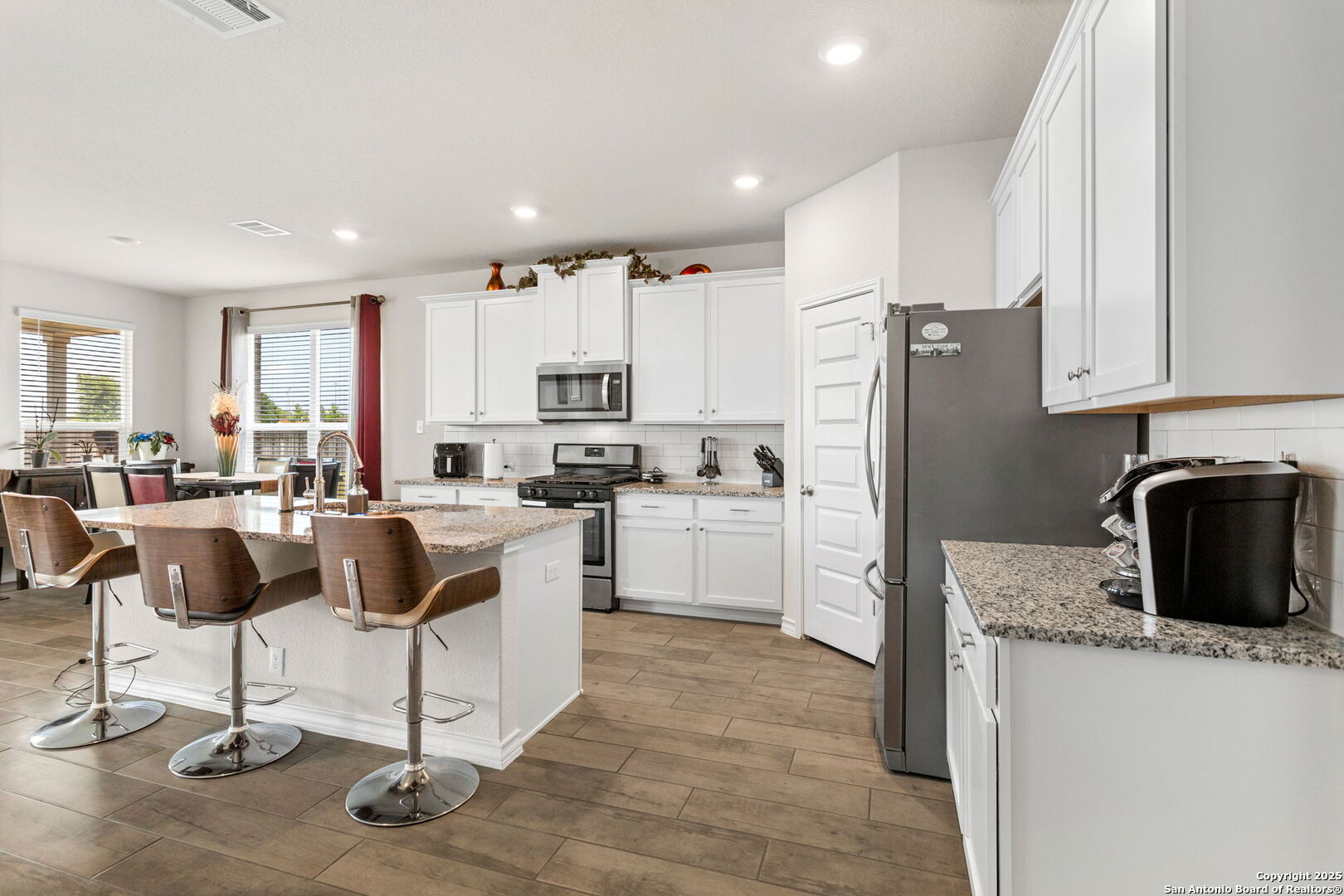 104 Mossy Bank Cibolo, TX 78108 - Photo 10 of 30 a kitchen with cabinets and chairs