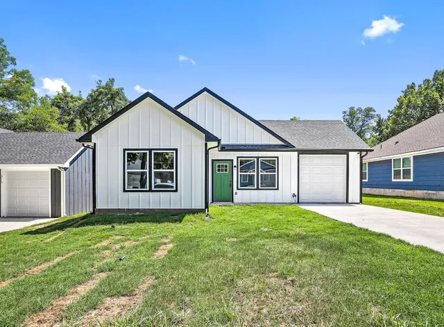 a front view of house with yard and green space