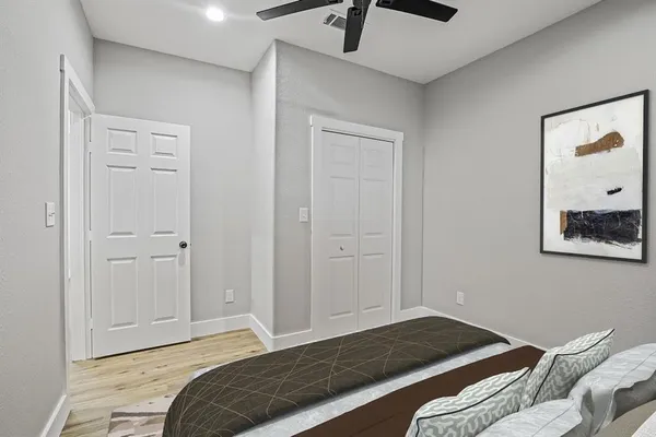 a bedroom with a bed and a painting on the wall