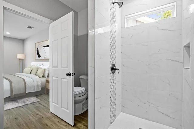 a bathroom with a bathtub and shower