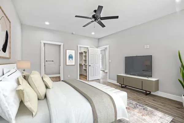 a bedroom with a bed and a flat screen tv