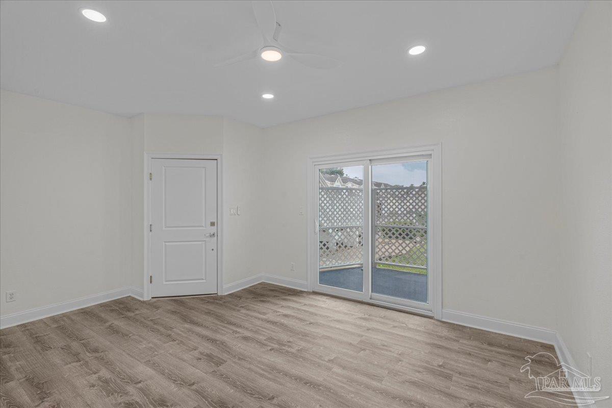 601 East Burgess Road, Unit C3 Pensacola, FL 32504 - Photo 17 of 35 wooden floor in an empty room with a window
