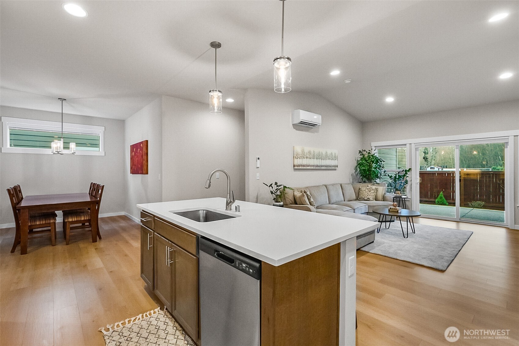 772 Parkland Loop Sedro-Woolley, WA 98284 - Photo 23 of 40 a open kitchen with stainless steel appliances granite countertop a stove a sink a dining table chairs and couches with wooden floor