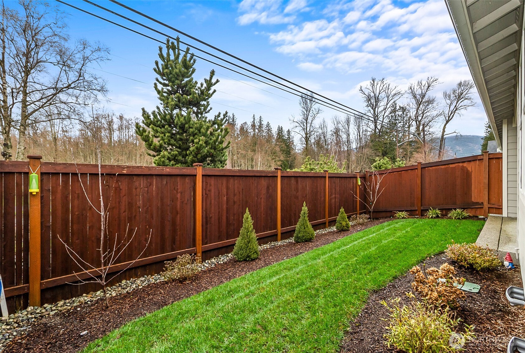 772 Parkland Loop Sedro-Woolley, WA 98284 - Photo 33 of 40 a view of a backyard with plants and wooden fence