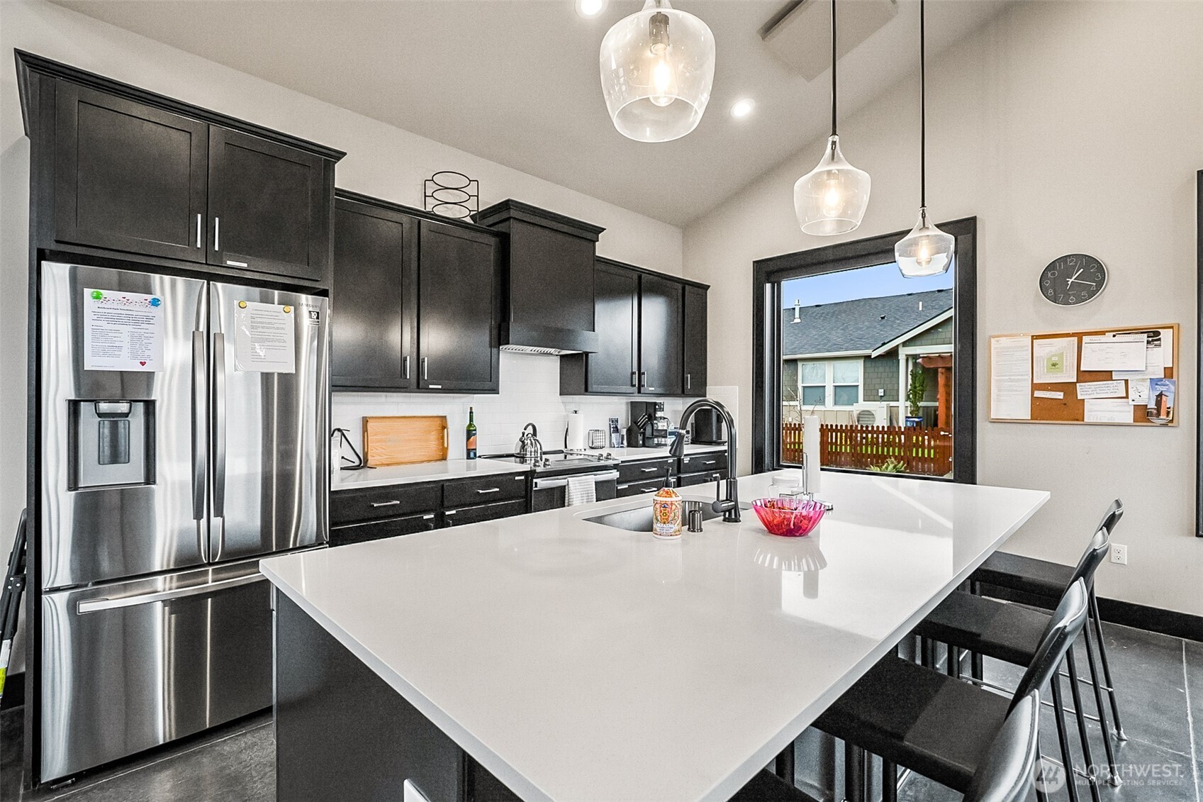 772 Parkland Loop Sedro-Woolley, WA 98284 - Photo 38 of 40 a kitchen with a dining table chairs refrigerator and microwave