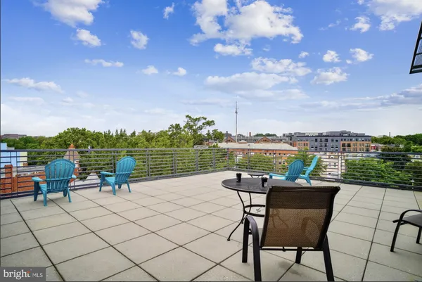 a view of a roof deck with furniture