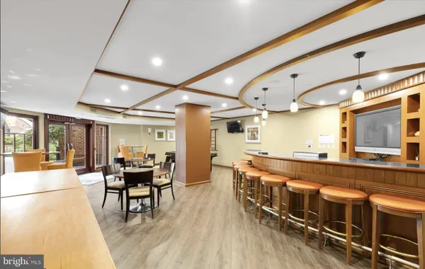 a large kitchen with a table and chairs