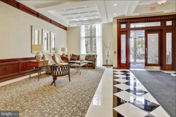 a living room with furniture and large windows