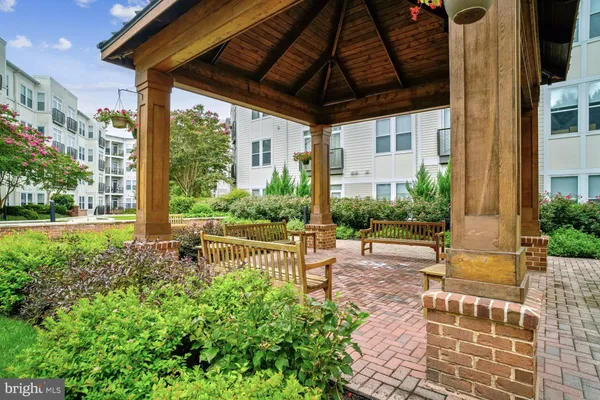 a view of a patio with table and chairs and potted plants