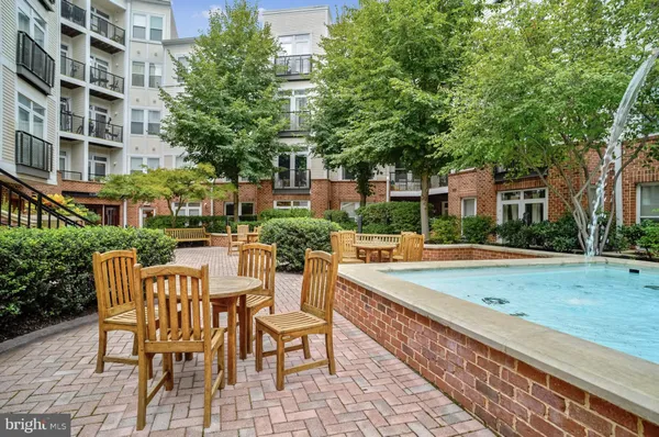 a view of a patio with dining table and chairs with wooden floor and fence