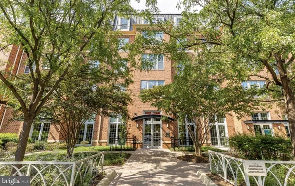 front view of a building with a tree