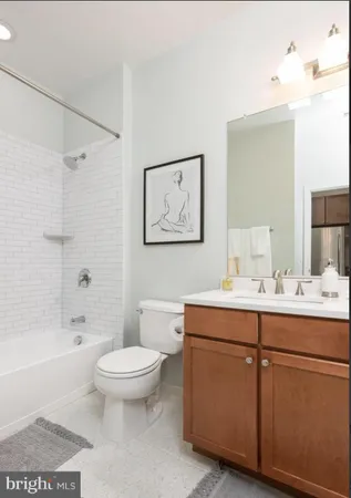 a spacious bathroom with a toilet a sink and a bathtub