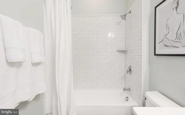 a bathroom with a bathtub and shower