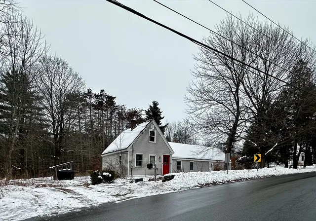 a front view of a house with a yard and tree s